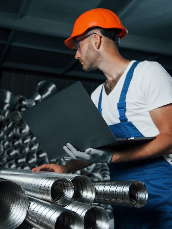 vertical-photo-man-in-uniform-works-on-the-production-industrial-modern-technology.jpg